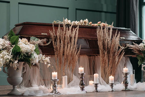 Flowers near a wooden coffin