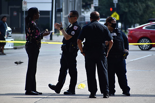 A african american woman speaking to a police officer