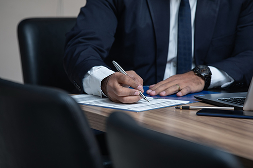 An attorney writing at a desk